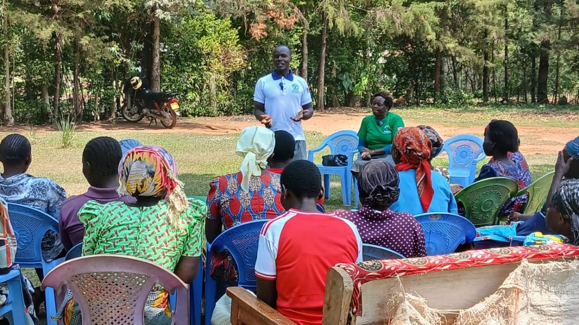CESUD field officer engaging in an open-air dialogue session with community women, widows, and teen mothers